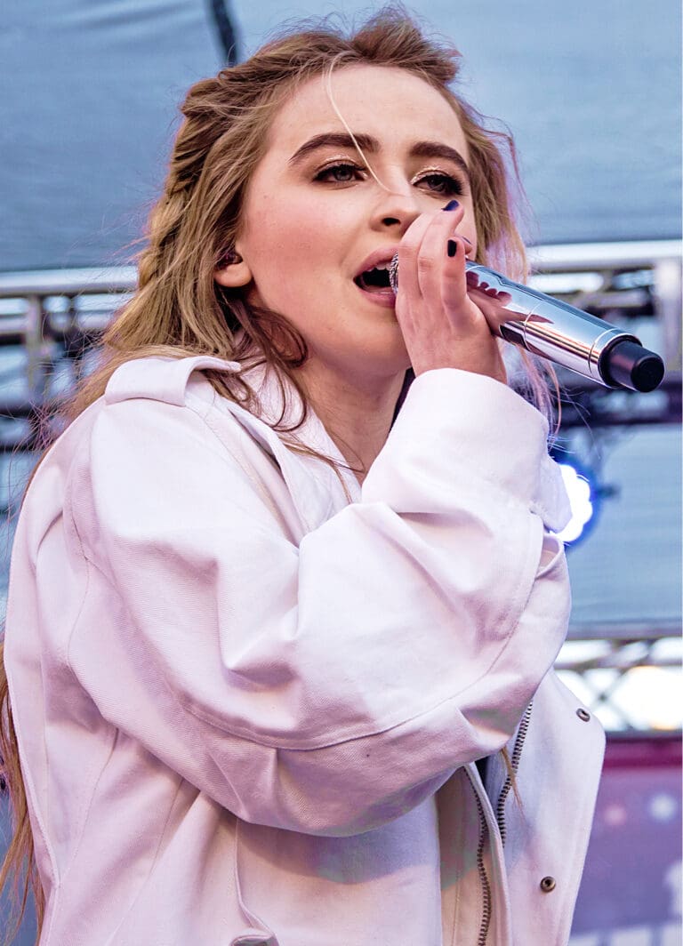Sabrina Carpenter reflects on Taylor Swift's grace and support during her rise in the music industry, celebrating chart-topping success. Photo by Justin Higuchi, WikiMedia.
